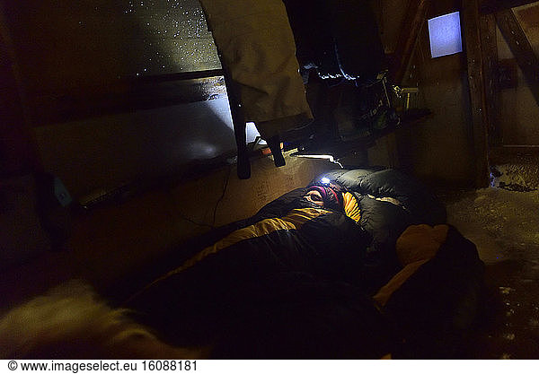 Explorer sleeping in a hut  Greenland  February 2016