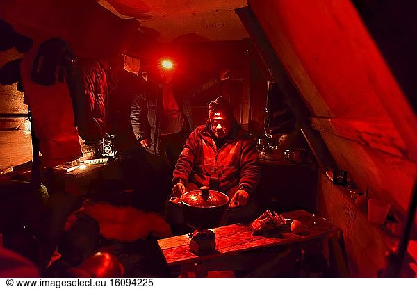 Explorers in a small hut in Greenland  February 2016  The red light doesn't dazzle them