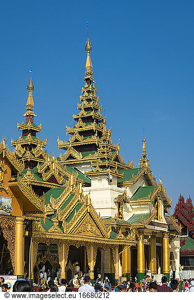 Exterior of Buddhist temple against clear blue sky at Shwedagon Pagoda complex  Yangon  Myanmar