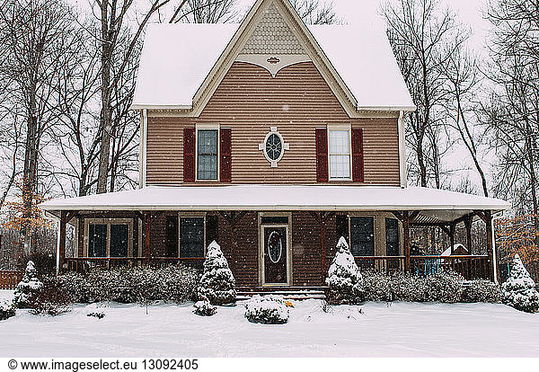 Exterior of snow covered house during snowfall
