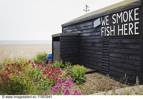 Exterior view of brown wooden fish shop on Suffolk coast.