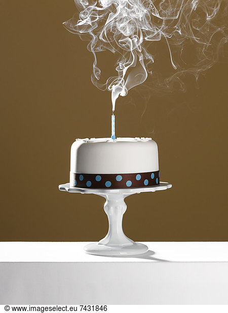 Extinguished birthday candle on birthday cake
