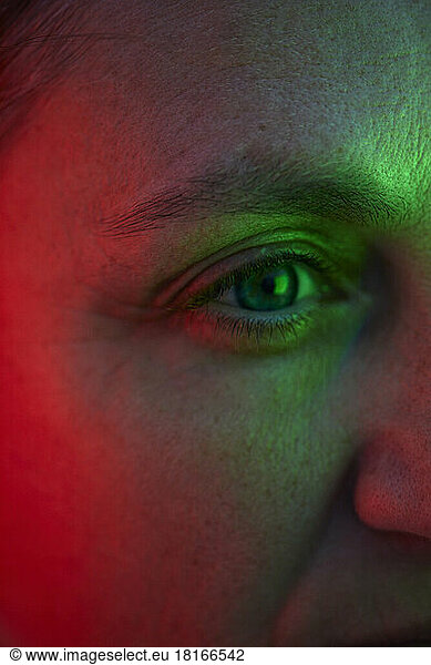 Eye of woman with reflection of red and green light