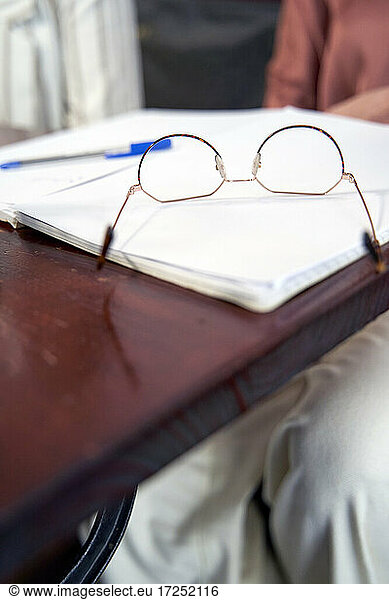 Eyeglasses on notebook at table