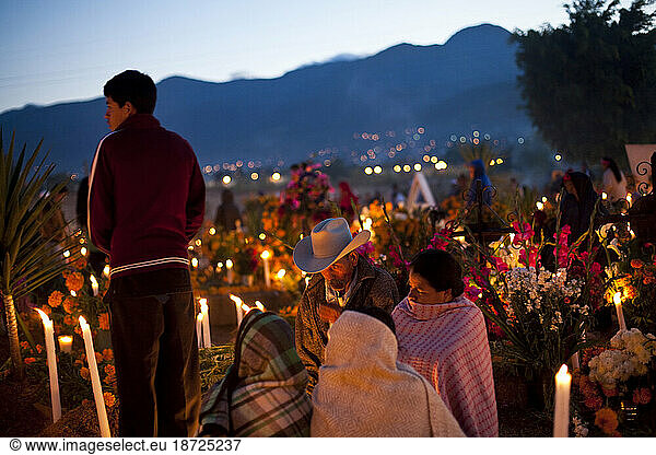Families gather to honor the deceased in the Atzompa cemetery during 'Dia de los Muertos' or Day of the Dead festivities in Oaxaca  Mexico  November 1  2008.