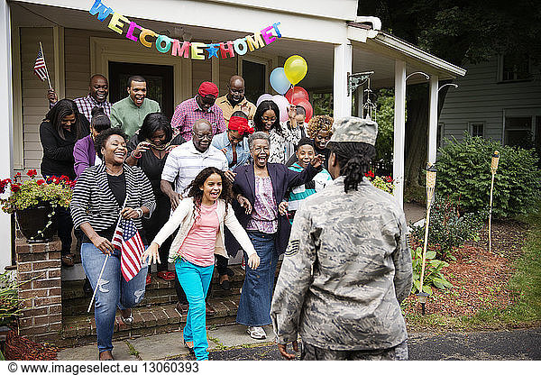 Family and friends welcoming female solider