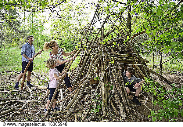Family building camp with log in forest