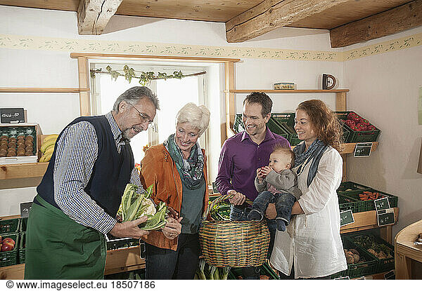 Family buying vegetables in the farm  Bavaria  Germany