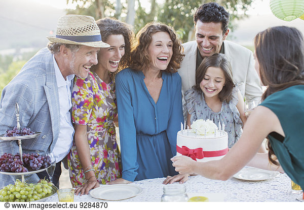 Family celebrating birthday with cake