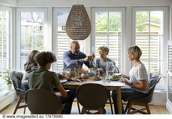Family eating food together at dining table