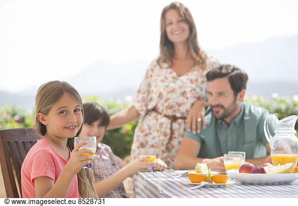 Family eating together at patio table