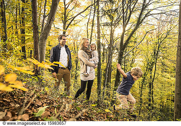 Family enjoying in forest during autumn