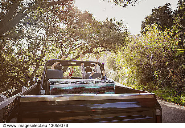 Family enjoying while travelling in off-road vehicle