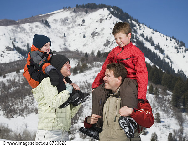 Family in front of snowy mountain