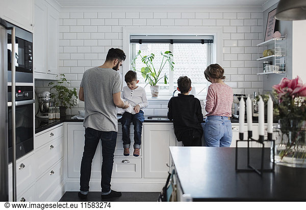 Family in kitchen at home