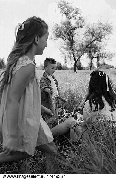 Family in the grass. Black and white photo