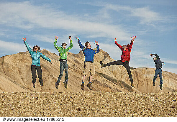 family jumping in the air at Landmannalaugar / Iceland