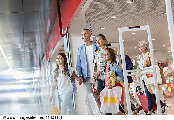 Family leaving duty free shop at airport