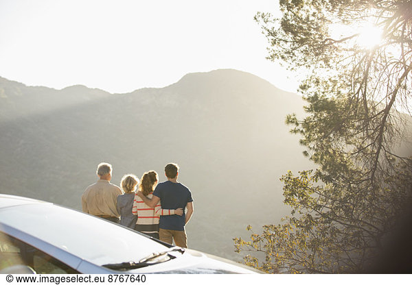 Family looking at mountain view outside car