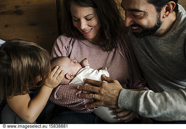 Family love embracing newborn baby
