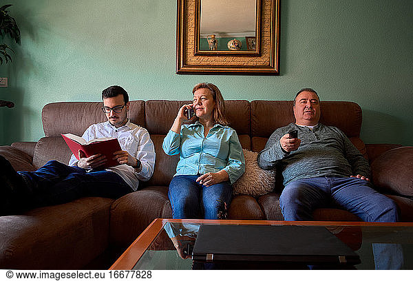 Family members do different things in their living room