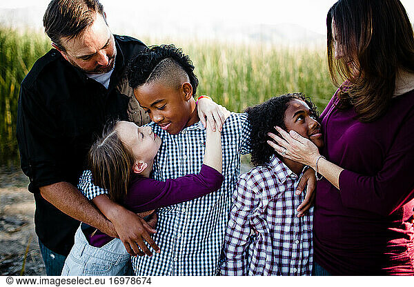 Family of Five Embracing at Park in Chula Vista