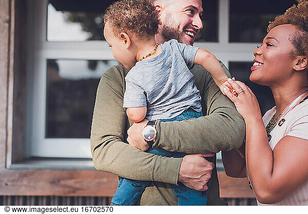 Family of three playing in Downtown  son is looking away