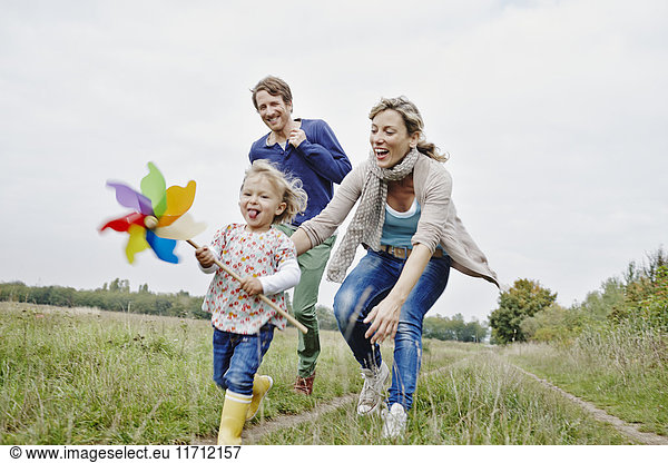Family on a trip with daughter holding pinwheel