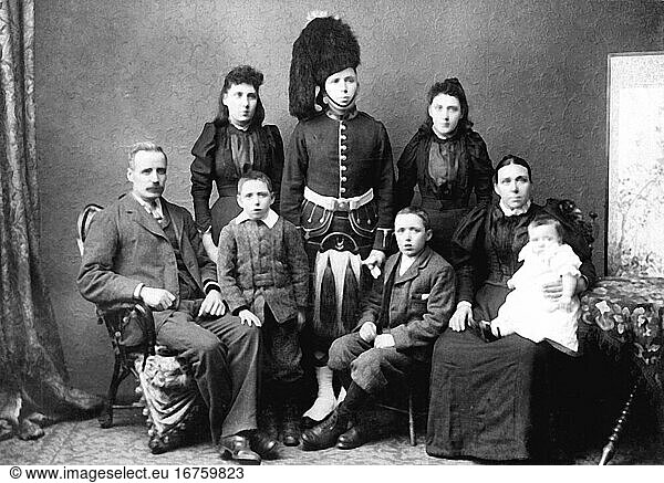 Family / Parents with Children. Group photo of a couple with six children  the eldest son in the uniform of the Scots Guards. Studio photo  undated  c. 1885
(A. & G. Taylor  Edingburgh).
From a private photo album.
Archie Miles Collection