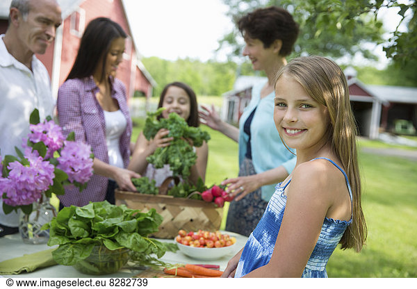 Family Party. A Table Laid With Salads And Fresh Fruits And Vegetables. Parents And Children.
