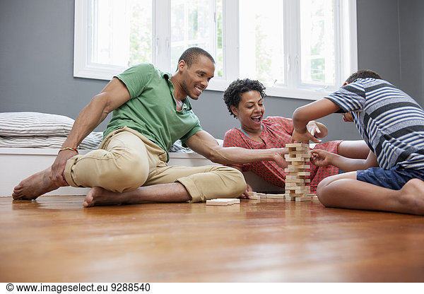 Family playing a game in living room.