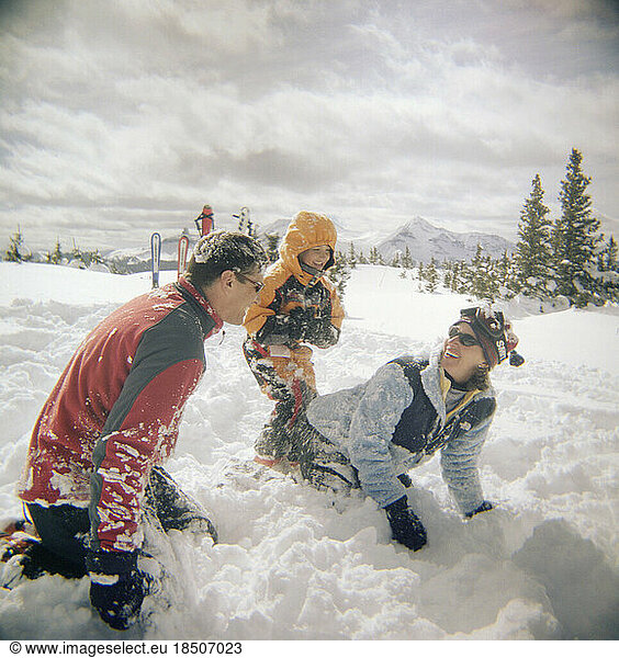 Family playing in the snow.
