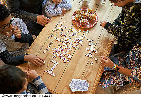 Family playing scrabble at dining table