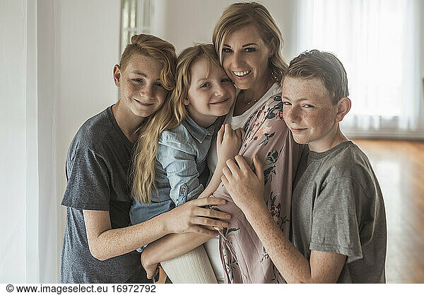 Family portrait of beautiful family with red hair smiling in studio