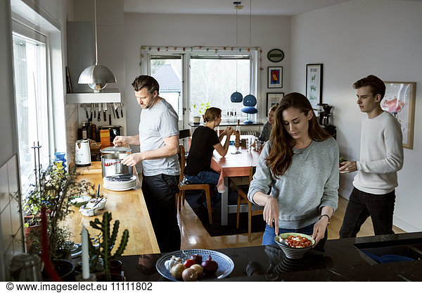 Family preparing food in kitchen