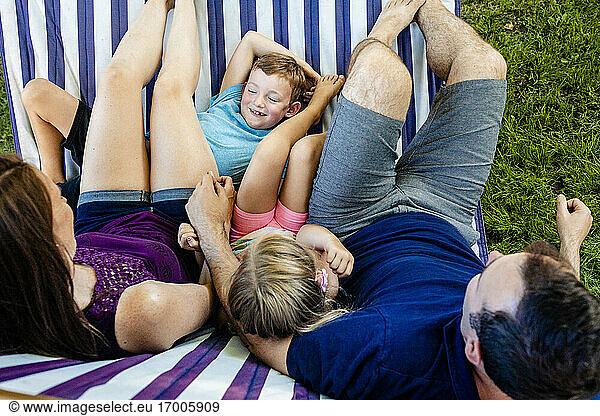 Family relaxing on hammock during weekend