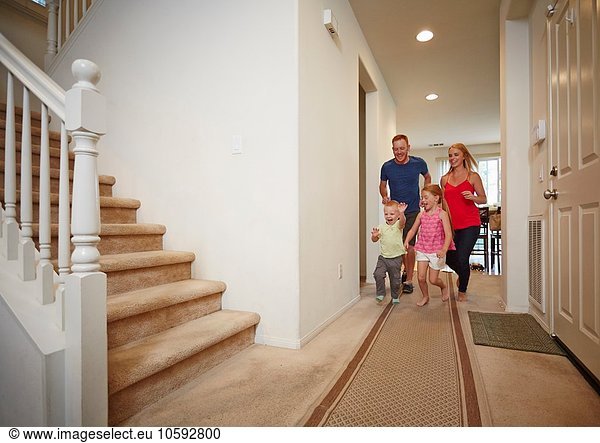 Family running in hallway at home