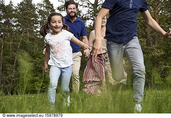 Family running on grass