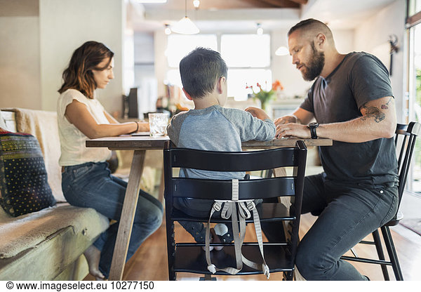 Family sitting at dining table in house