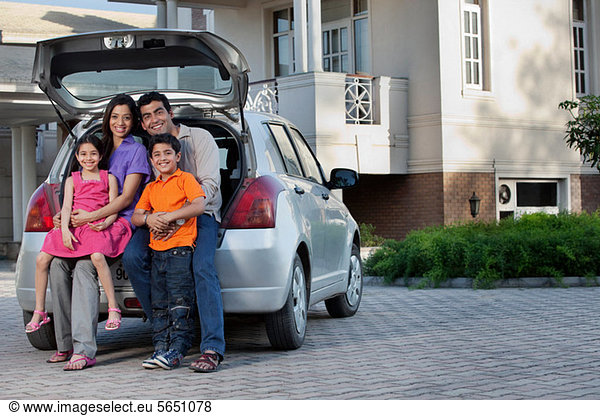 Family sitting at the back of a car