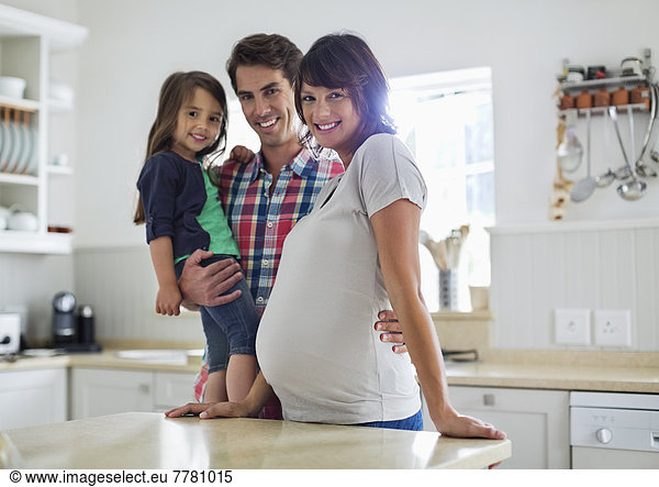 Family smiling together in kitchen