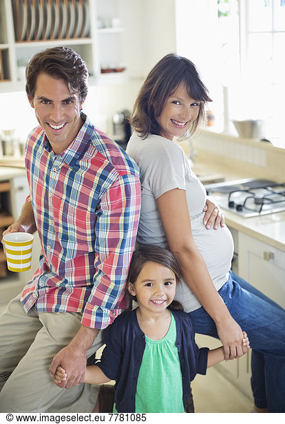 Family smiling together in kitchen