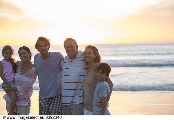 Family smiling together on beach