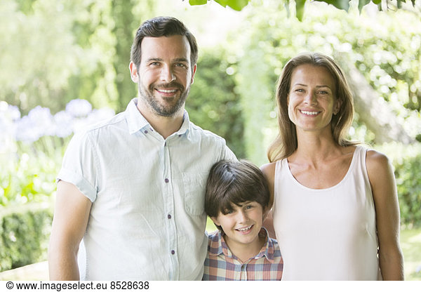 Family smiling together outdoors