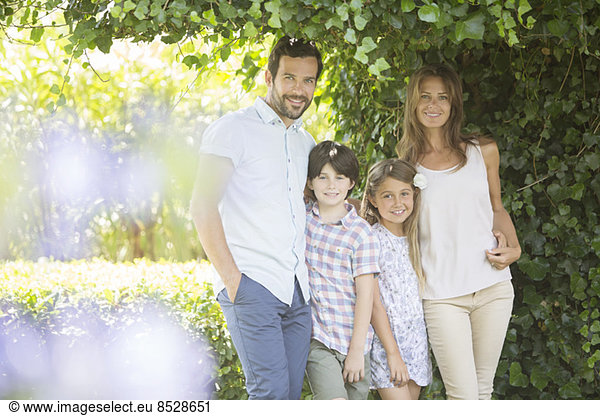 Family smiling under ivy