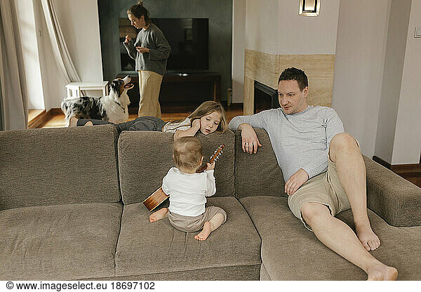 Family spending leisure time together in living room at home