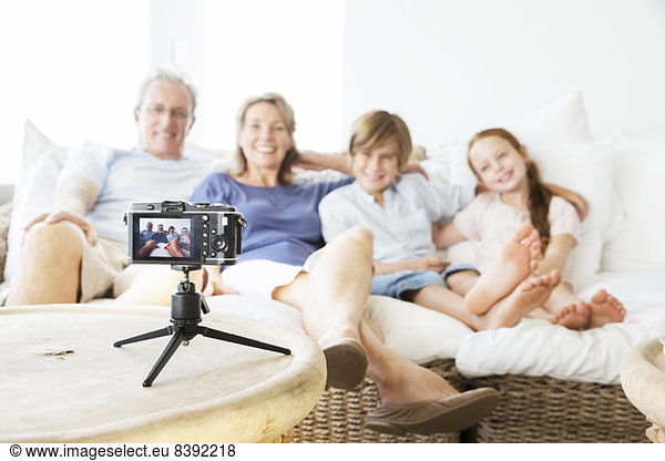 Family taking picture of themselves on sofa