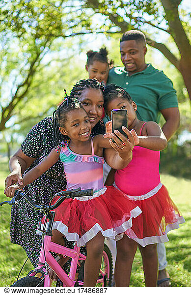 Family taking selfie in summer park