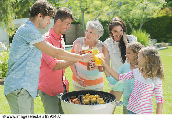 Family toasting each other at barbecue