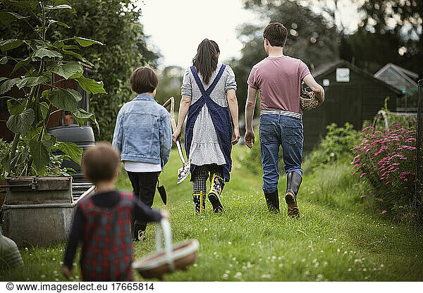 Family walking in backyard garden grass